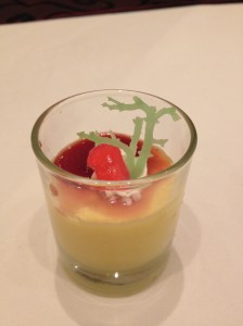 Mango mousse topped with a sprig of seaweed